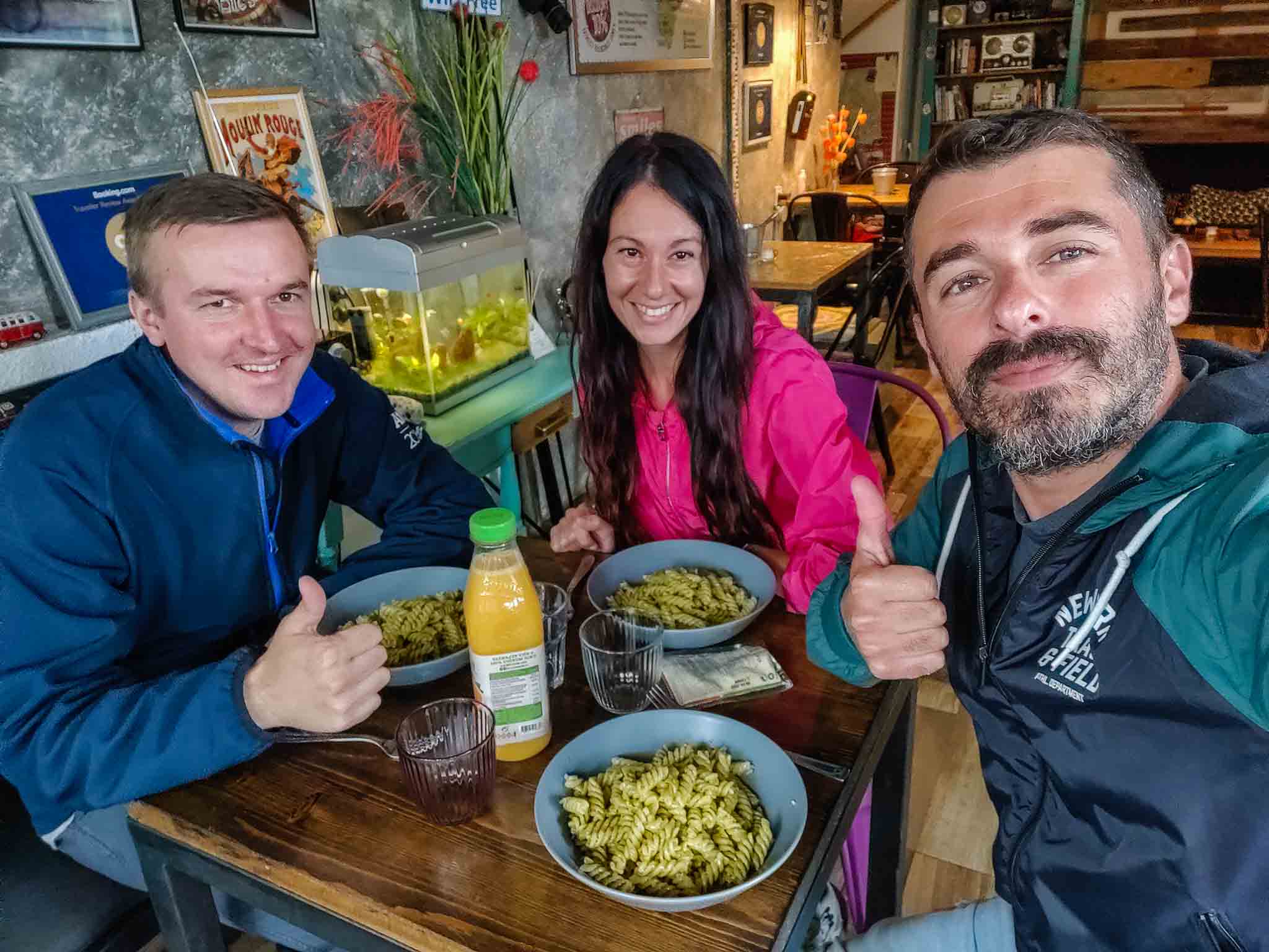 Three people eating in a hostel