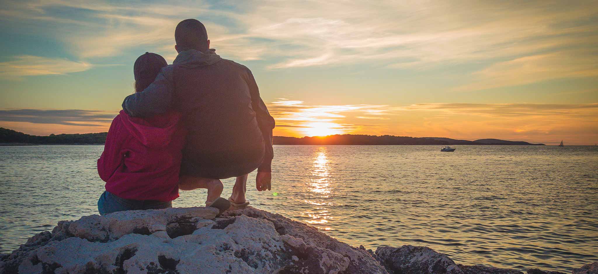 A couple watching sunset near the sea