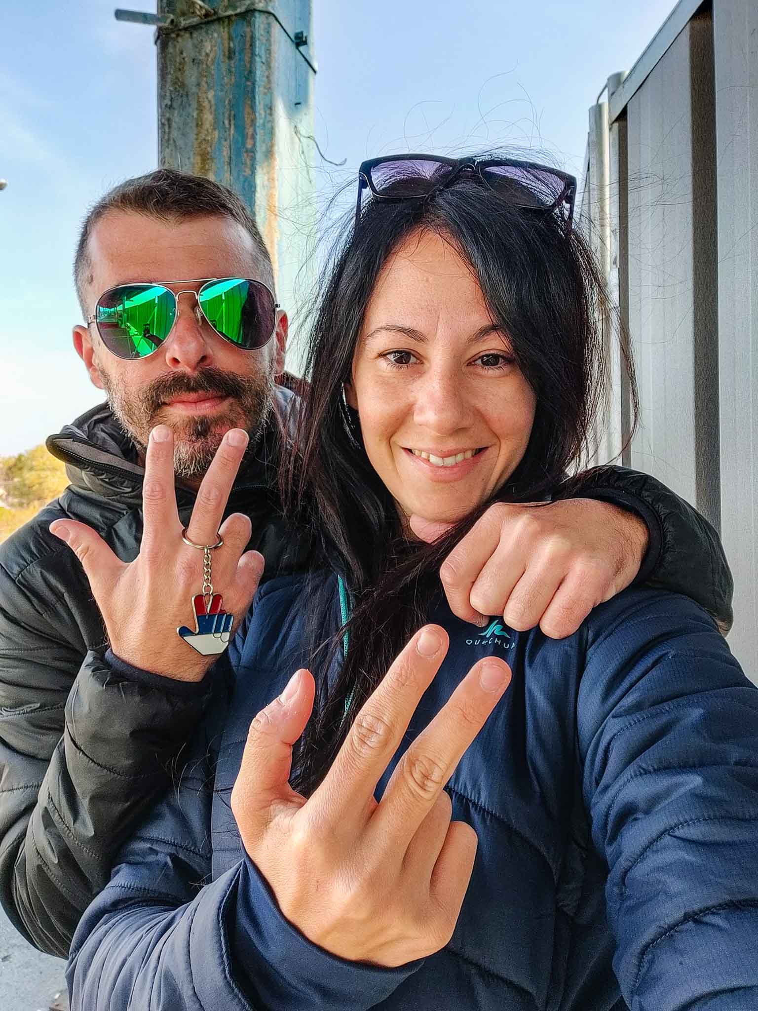 A couple doing the Serbian Three Finger Salute