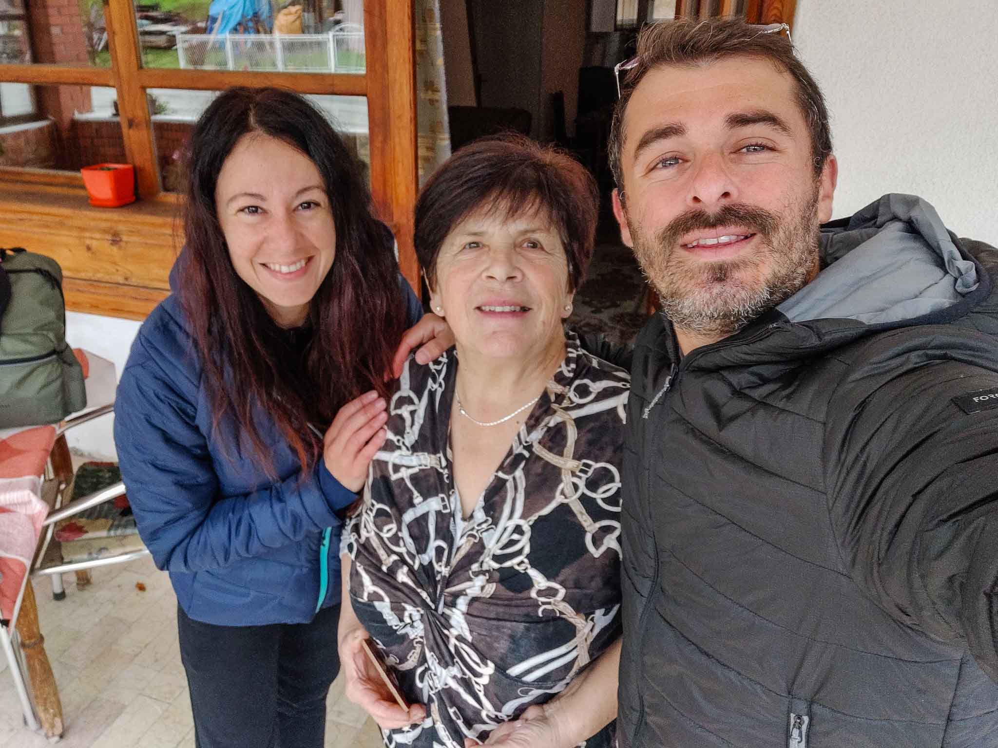 A couple with their host at her cottage